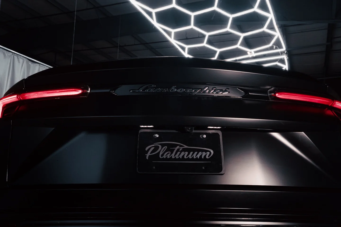 Lamborghini rear with Platinum Auto Care plate frame under studio lighting, prepared for presentation