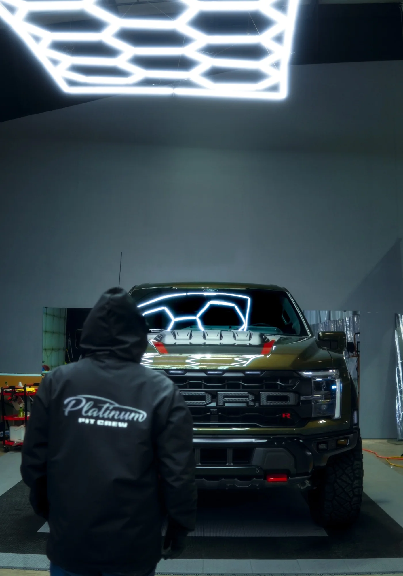 Platinum Auto Care technician applying protection to a collector vehicle in the Portland studio