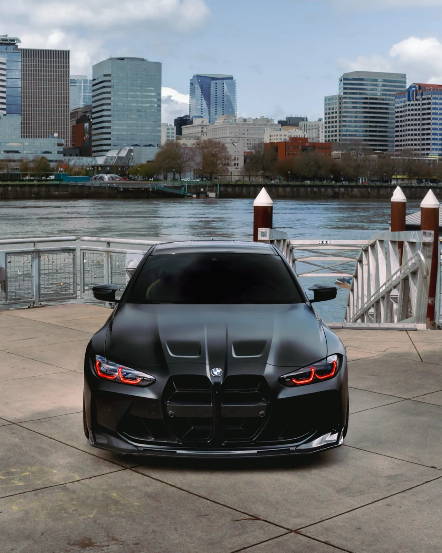 Detailed BMW M4 on the Portland waterfront with the city skyline behind