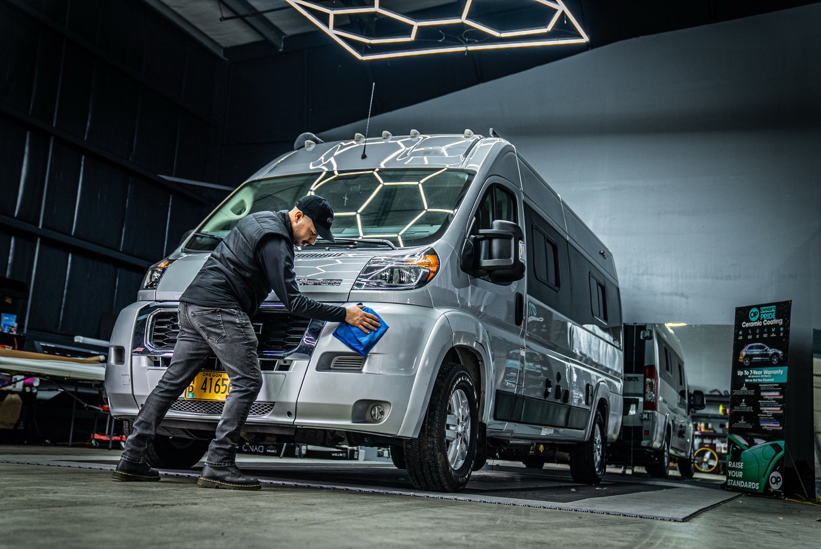 Platinum Auto Care technician detailing a Winnebago Travato RV in Portland